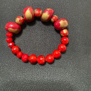 Red bracelet with gold hand crafted